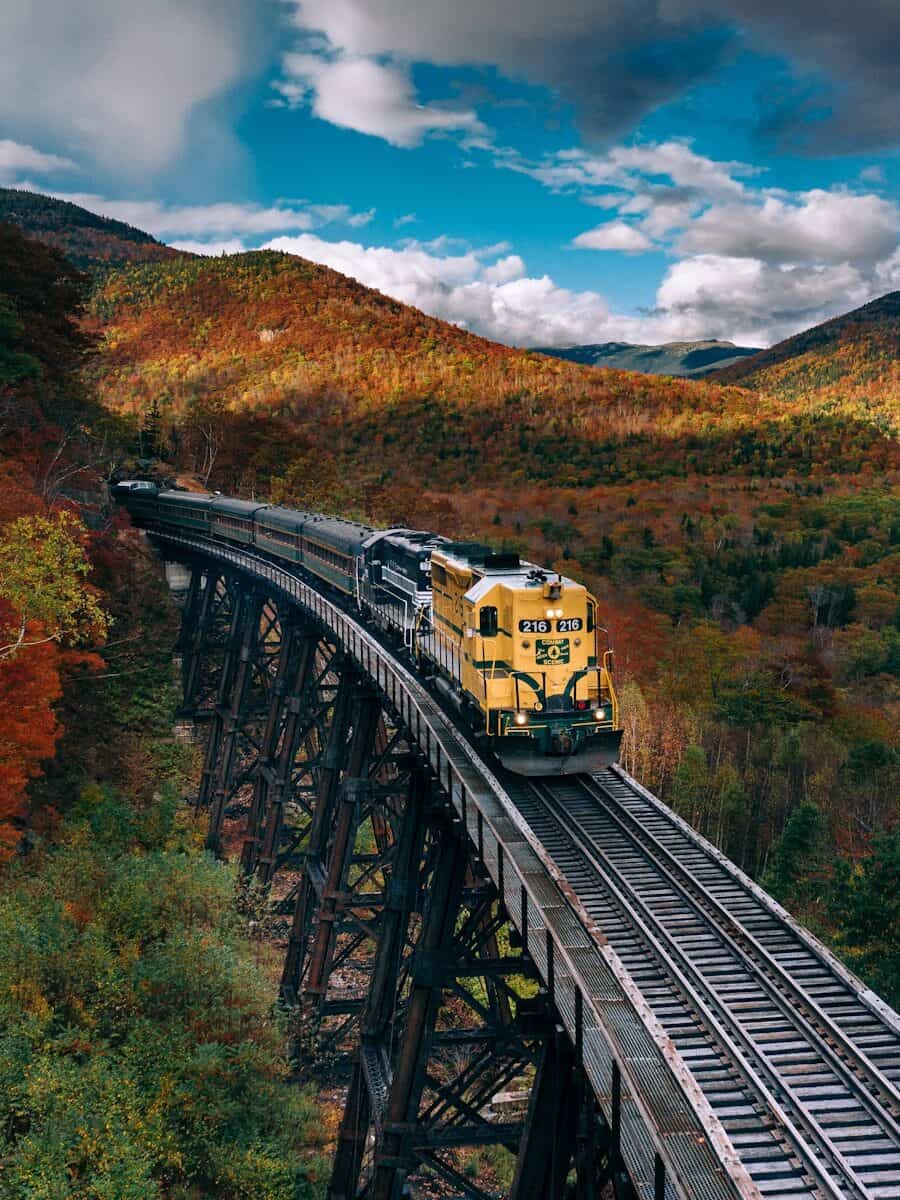 yellow train on rail tracks during daytime